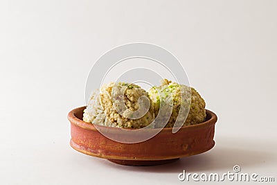 moa, popular bengali dessert is served on a clay plate. this is made of jaggery, puffed rice and made into a ball. famous sweet Stock Photo