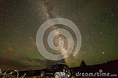 An SUV under the bright Milky Way galaxy stars, Moab Utah Editorial Stock Photo