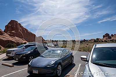 Extremely crowded and busy parking lot, filled with cars at the Devils Garden trail in Arches National Editorial Stock Photo