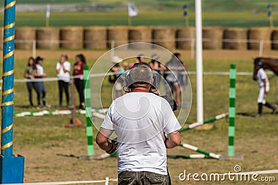 Working videographer on local horse race. Editorial Stock Photo