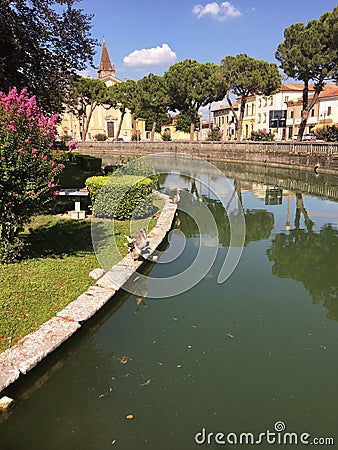 Moat along the castle of Zevio, Verona, Italy, with geese along the shore. Stock Photo