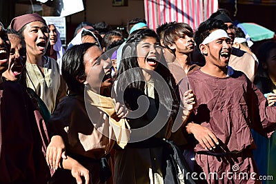 Mob of men and women marching shouting, chanting creating trouble on street Editorial Stock Photo