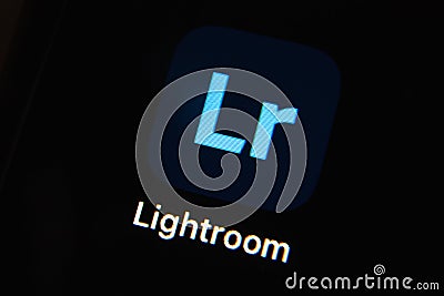 Mobile Adobe lightroom app icon isolated on black iPhone screen. Editorial Stock Photo