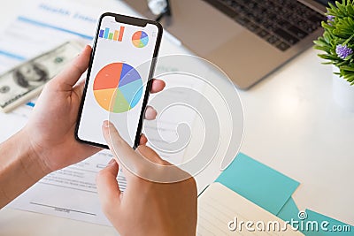 Mobile analytics smartphone on business hand with showing data. Stock Photo