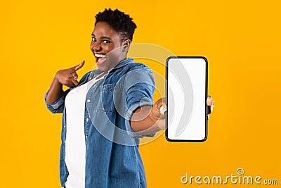 Excited African Woman Showing Phone Screen Recommending Application, Yellow Background Stock Photo