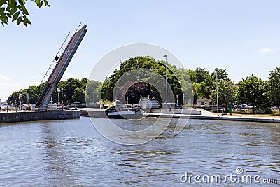 Mobile bridge rise up so that a cargo ship can pass Stock Photo