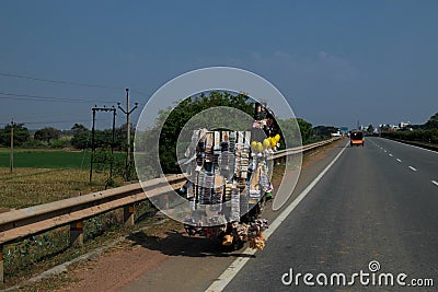 A mobile cart loaded with lots of supplies on a highway Editorial Stock Photo