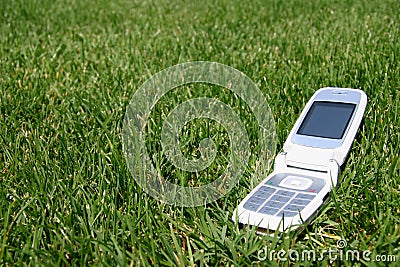 Mobile cell phone on grass outside Stock Photo