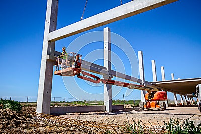 Mobile crane is carry concrete joist to assembly huge hall Stock Photo