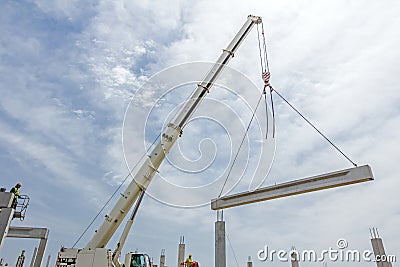 Mobile crane is carry concrete joist to assembly huge hall Editorial Stock Photo