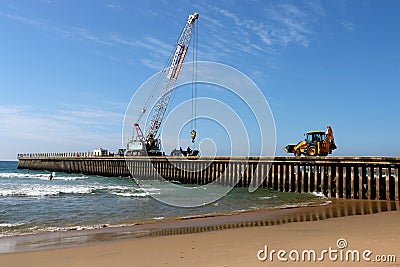 Mobile Crane And Pay loader on Pier Construction Site Editorial Stock Photo