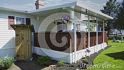 Mobile, Manufactured, Modular, Prefabbed Home With a Deck and Outhouse Stock Photo