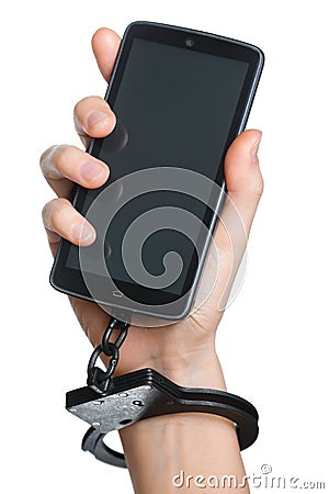 Mobile phone addiction concept. Smartphone and handcuff in hand Stock Photo