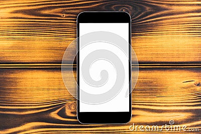 Mobile phone with blank screen mock up isolated on burned wood table background. Smartphone on wood table. Smartfone white Stock Photo