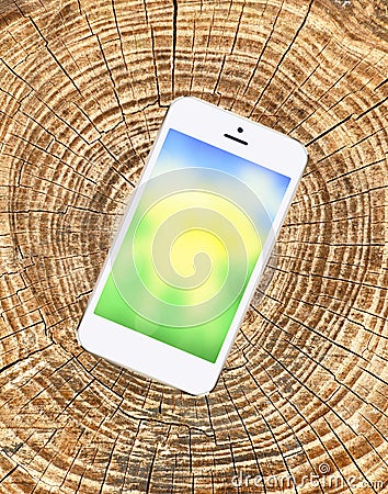 Mobile phone with bright screen on wooden cracked background Stock Photo