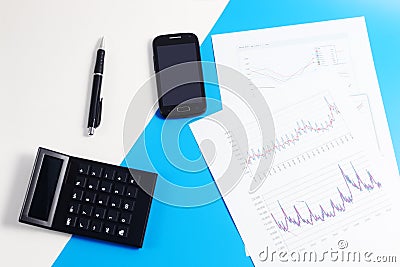 Mobile phone, calculator, diagrams, graphs, documents, pen Stock Photo