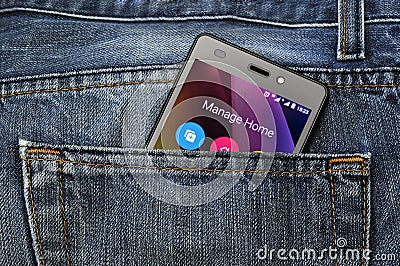 Mobile phone, cellphone in back pocket blue jeans Stock Photo