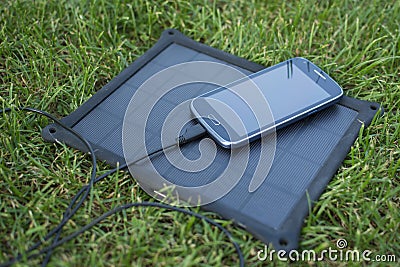 Mobile phone charging with solar energy - charger Stock Photo