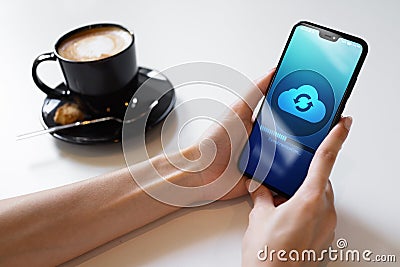 Mobile phone cloud synchronisation process on device screen. Technology concept. Stock Photo