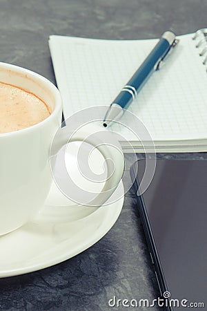 Mobile phone, coffee with milk and notepad for writing notes. Work or relaxation Stock Photo