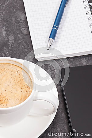 Mobile phone, coffee with milk and notepad for writing notes. Work or relaxation Stock Photo