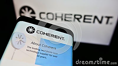 Mobile phone with company webpage of US laser manufacturer Coherent Inc. on screen in front of business logo. Editorial Stock Photo