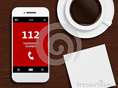 Mobile phone with emergency number 112 lying on desk Stock Photo