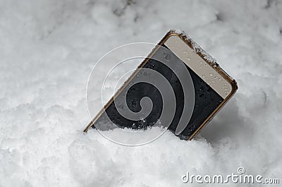 The phone fell in a snowdrift Stock Photo