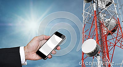 Mobile phone on hand with copy space, and telecommunication tower with satellite dish telecom network on blue sky with sun Stock Photo