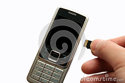 Mobile phone and hand with memory card Stock Photo