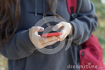 Mobile phone in hands of unrecognizable young girl close-up, modern tehnology Stock Photo