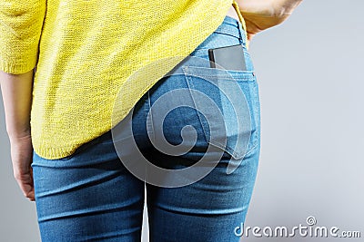 Mobile phone in jeans pocket Stock Photo