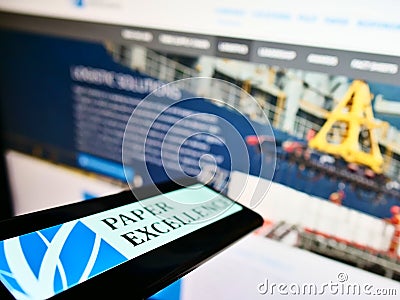 Mobile phone with logo of Canadian paper and pulp manufacturer Paper Excellence on screen in front of website. Editorial Stock Photo