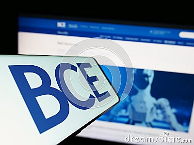 Mobile phone with logo of Canadian telecommunications company BCE Inc. on screen in front of business website. Editorial Stock Photo