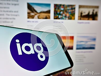 Mobile phone with logo of company Insurance Australia Group Limited (IAG) on screen in front of website. Editorial Stock Photo