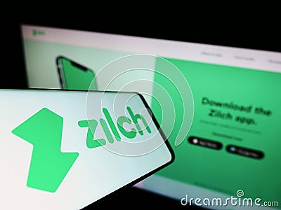 Mobile phone with logo of fintech Zilch Technology Limited (PayZilch) on screen in front of business website. Editorial Stock Photo