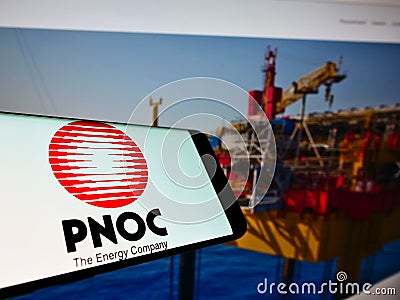 Mobile phone with logo of Philippine National Oil Company (PNOC) on screen in front of business website. Editorial Stock Photo