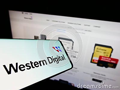 Mobile phone with logo of US company Western Digital Corporation (WDC) on screen in front of website. Editorial Stock Photo