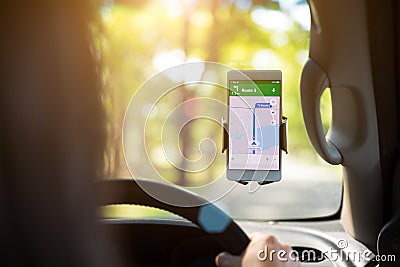 Mobile phone with map gps navigation in car. Stock Photo