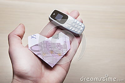 Mobile phone money hand table background Stock Photo