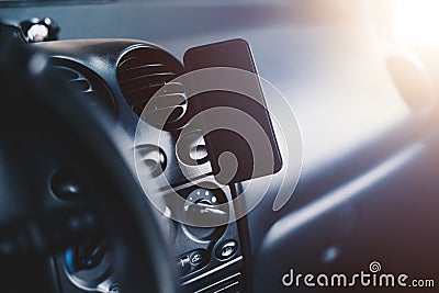 A mobile phone mounted on magnetic car mount Stock Photo