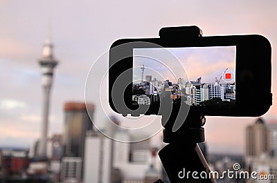 Mobile phone photographing and filming a rainbow in a rain cloud Stock Photo