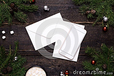 Mobile phone and postcard on a wooden table with a Christmas tree Stock Photo