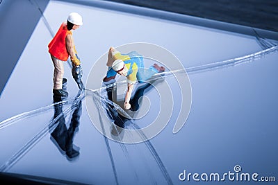 Mobile phone repair service concept. Miniature technician people repairing a cracked smart phone screen. Close up image. Stock Photo