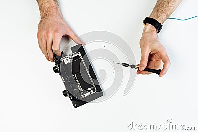 Mobile phone repairman hand on workplace flat lay Stock Photo