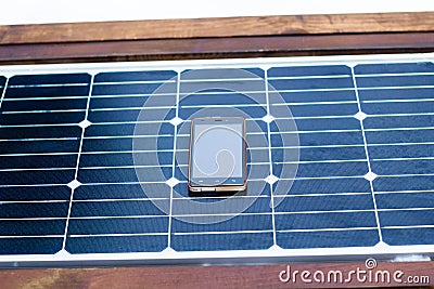 Mobile phone on a solar panel outdoor close up Stock Photo