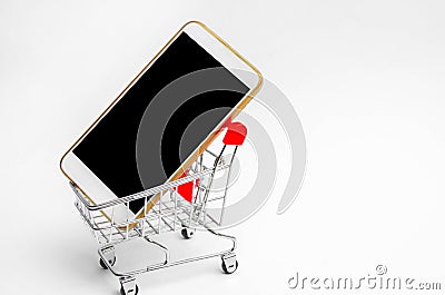 Mobile phone in a supermarket trolley. buying and selling a smartphone. online store. consumer credit. isolated white background Stock Photo