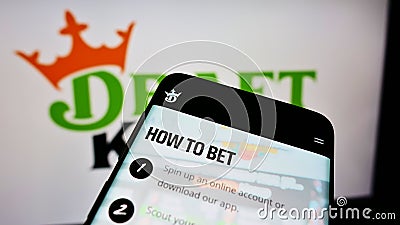 Mobile phone with website of American sports betting company DraftKings Inc. on screen in front of logo. Editorial Stock Photo