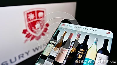 Mobile phone with website of Australian winemaking company Treasury Wine Estates Limited on screen with logo. Editorial Stock Photo