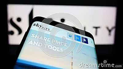 Mobile phone with website of company SkyCity Entertainment Group Limited on screen in front of business logo. Editorial Stock Photo